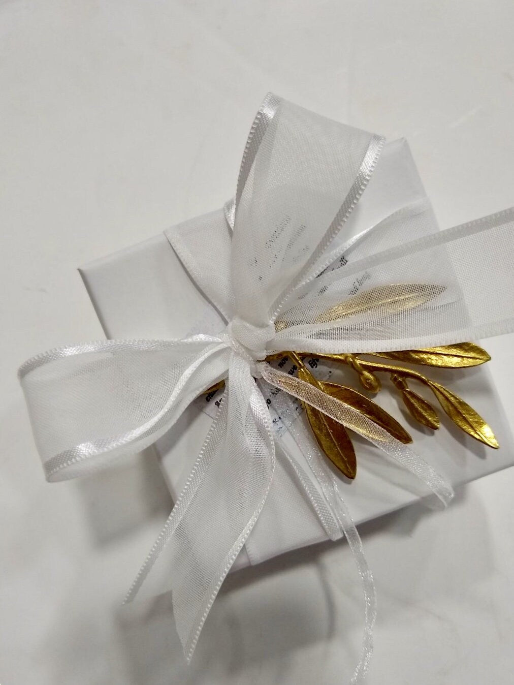 50 wedding favors handmade cast bronze olive twigs placed on a box with satin ribbons. Sugared almonds inside