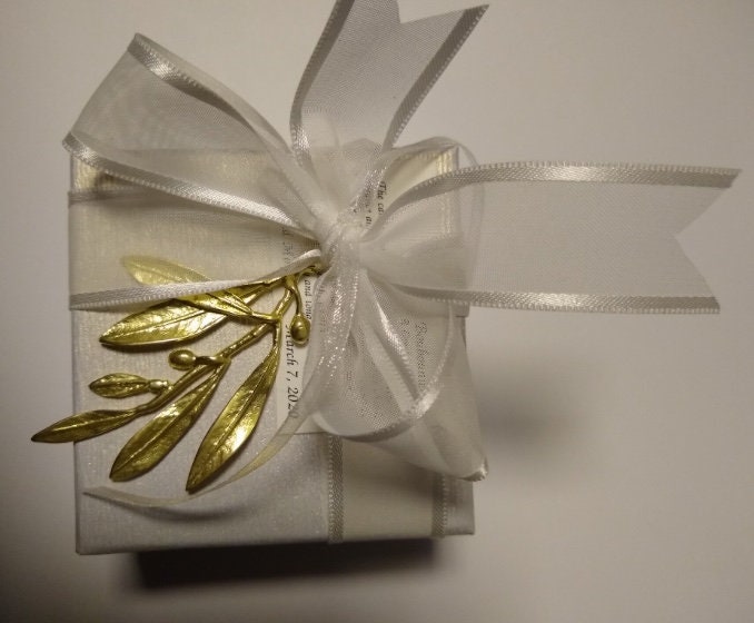 50 wedding favors handmade cast bronze olive twigs placed on a box with satin ribbons. Sugared almonds inside